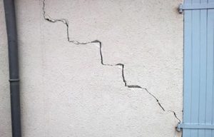 Cracked wall, likely due to structural issues.
